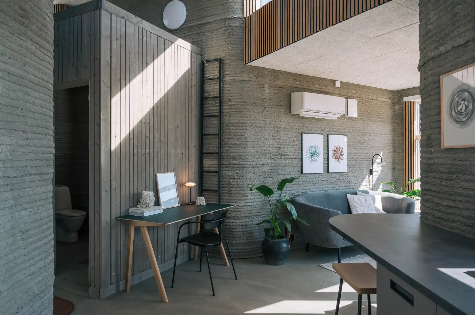 Interior view of 3DCP Group's 3D printed concrete house, showing curved walls