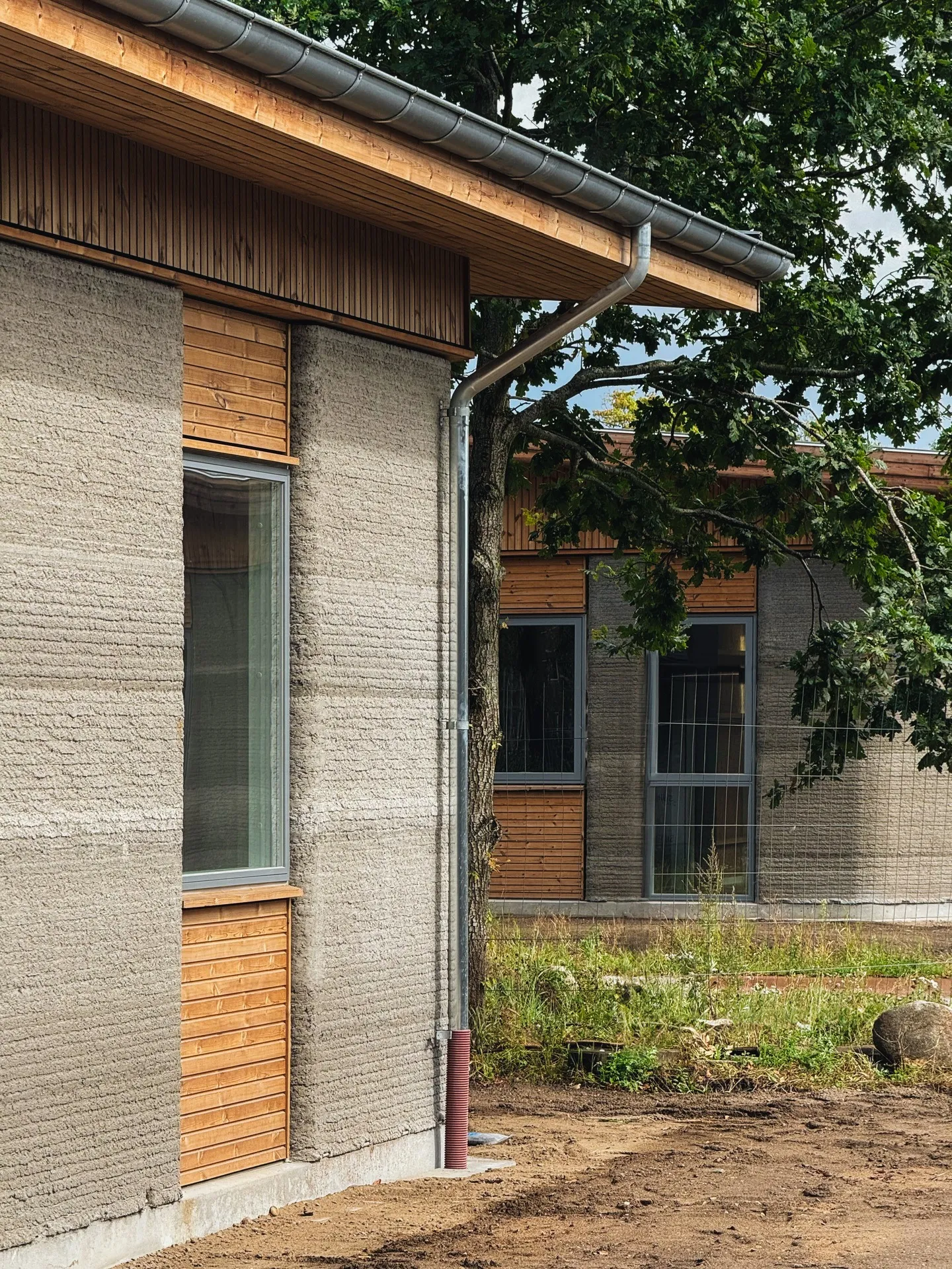 Completed home with exposed printed walls and timber cladding